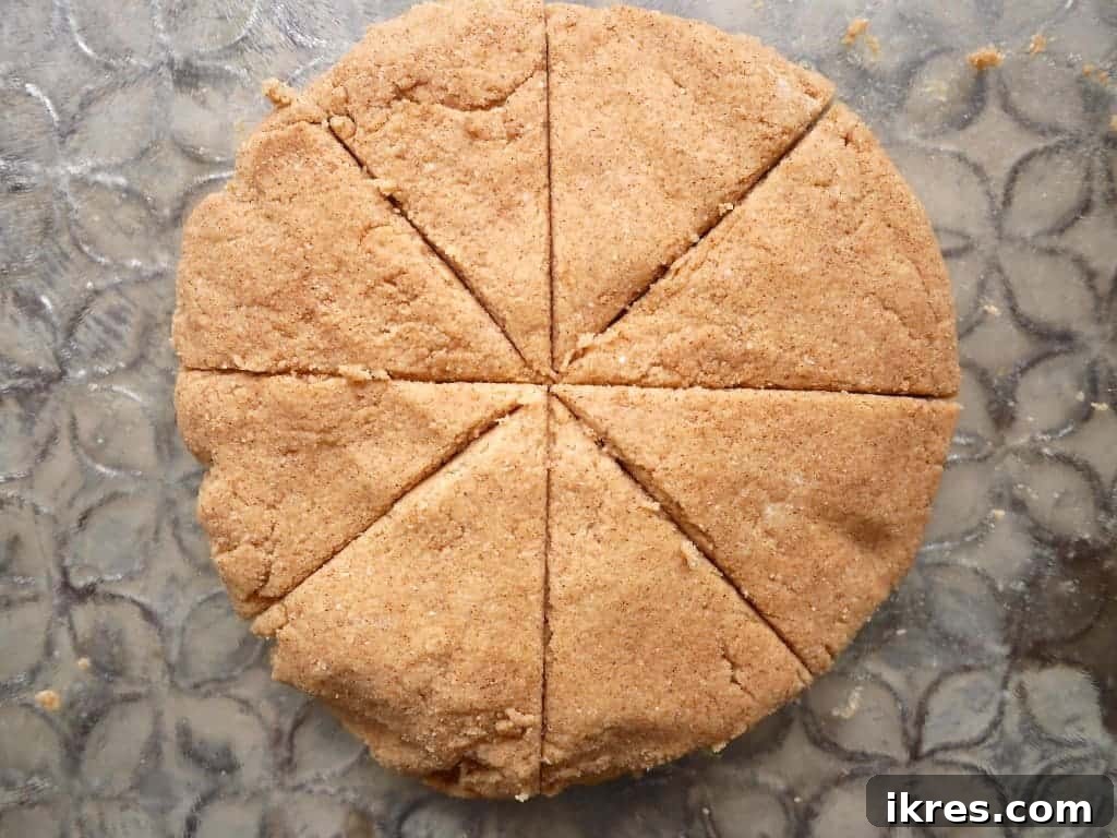 Cinnamon Paleo Scones 6 Paleo scone batter cut into 8 triangular pieces.