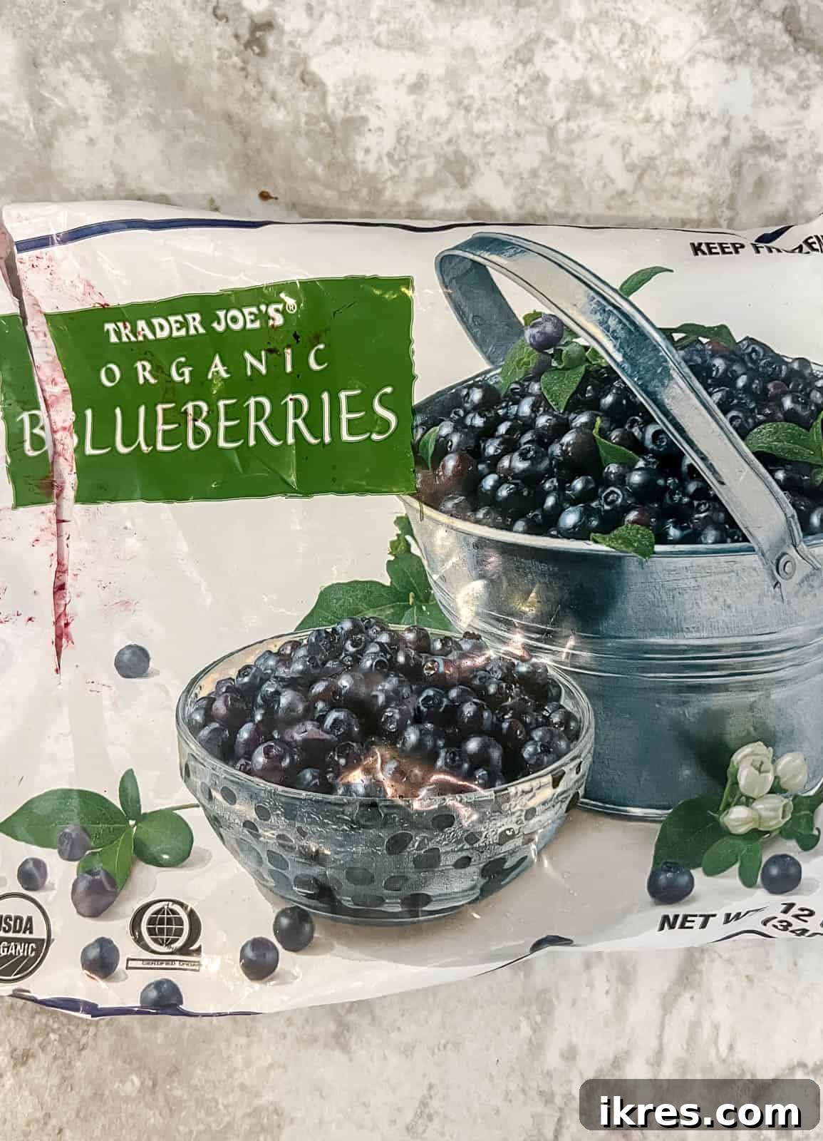 A bowl of frozen blueberries, ready to be incorporated into the healthy blueberry banana bread batter.