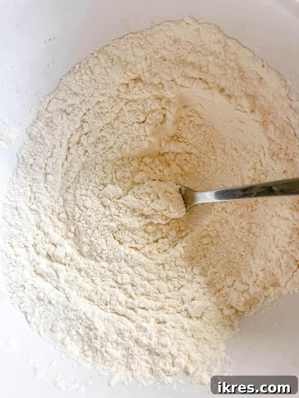 Dry ingredients (flour, salt, baking soda) being whisked together in a separate bowl.