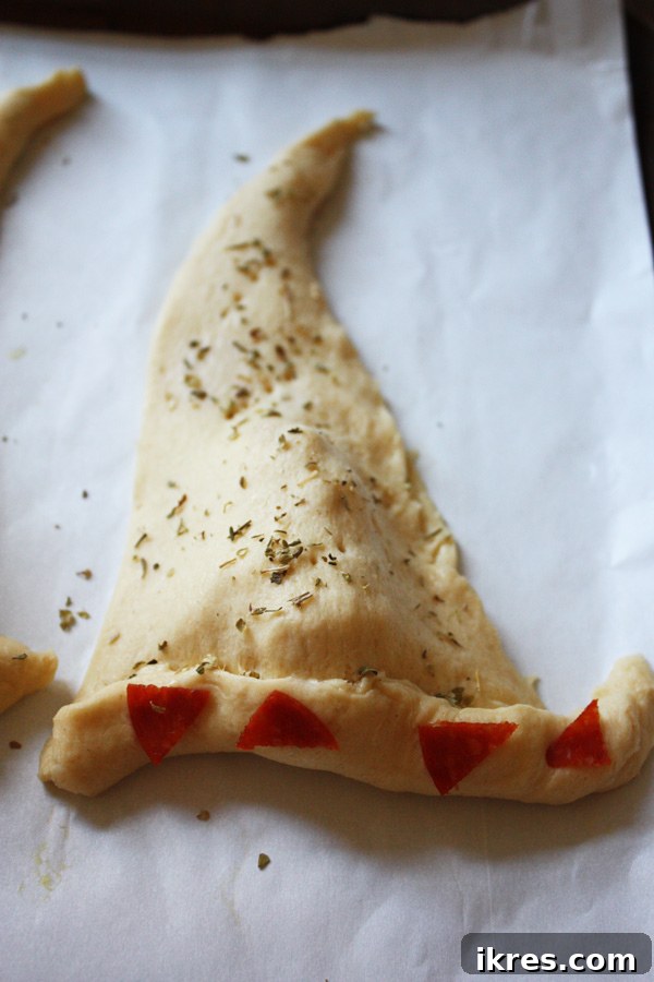Bewitching Calzone Caps 10 The calzone shaped into a witch hat with the seasoning and pepperoni on top.