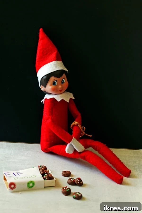 Elven Delights 2 An Elf on the Shelf sitting beside a plate of tiny Elf Donuts, ready to enjoy a festive holiday treat.