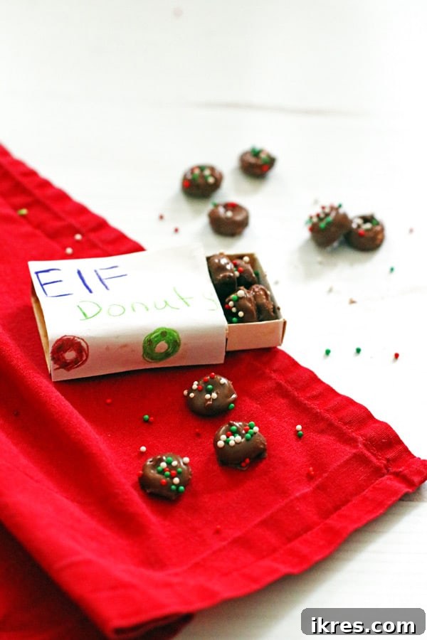 Elven Delights 10 A charming miniature DIY donut box, crafted from a matchbox, holds a selection of tiny Elf Donuts, ready for a special delivery.