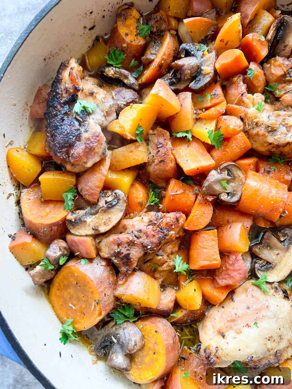 The fully cooked Maple Peach Chicken Thighs in a Dutch oven, ready to be served, showcasing tender chicken, softened peaches, and a rich sauce.