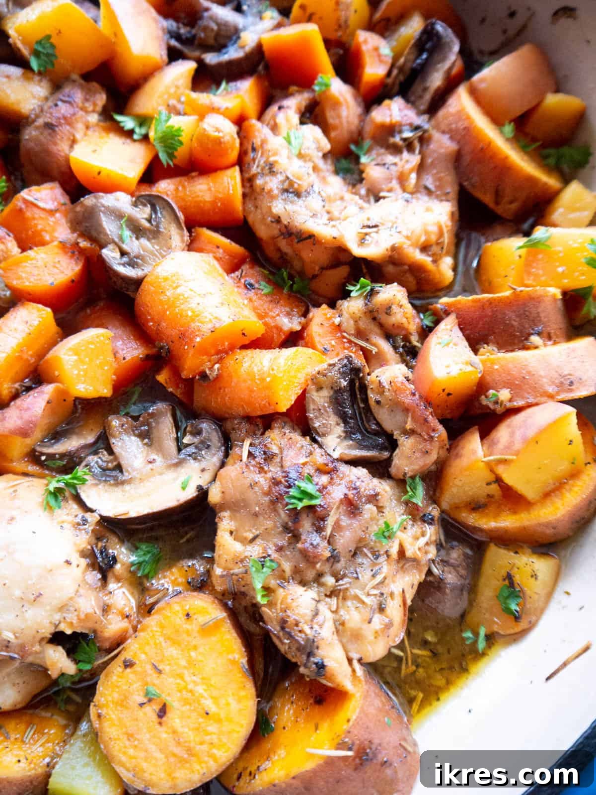 A high-resolution, close-up photograph of the cooked Dutch Oven Maple Peach Chicken Thighs, showcasing the tender chicken, vibrant peaches, and the rich, glossy sauce.