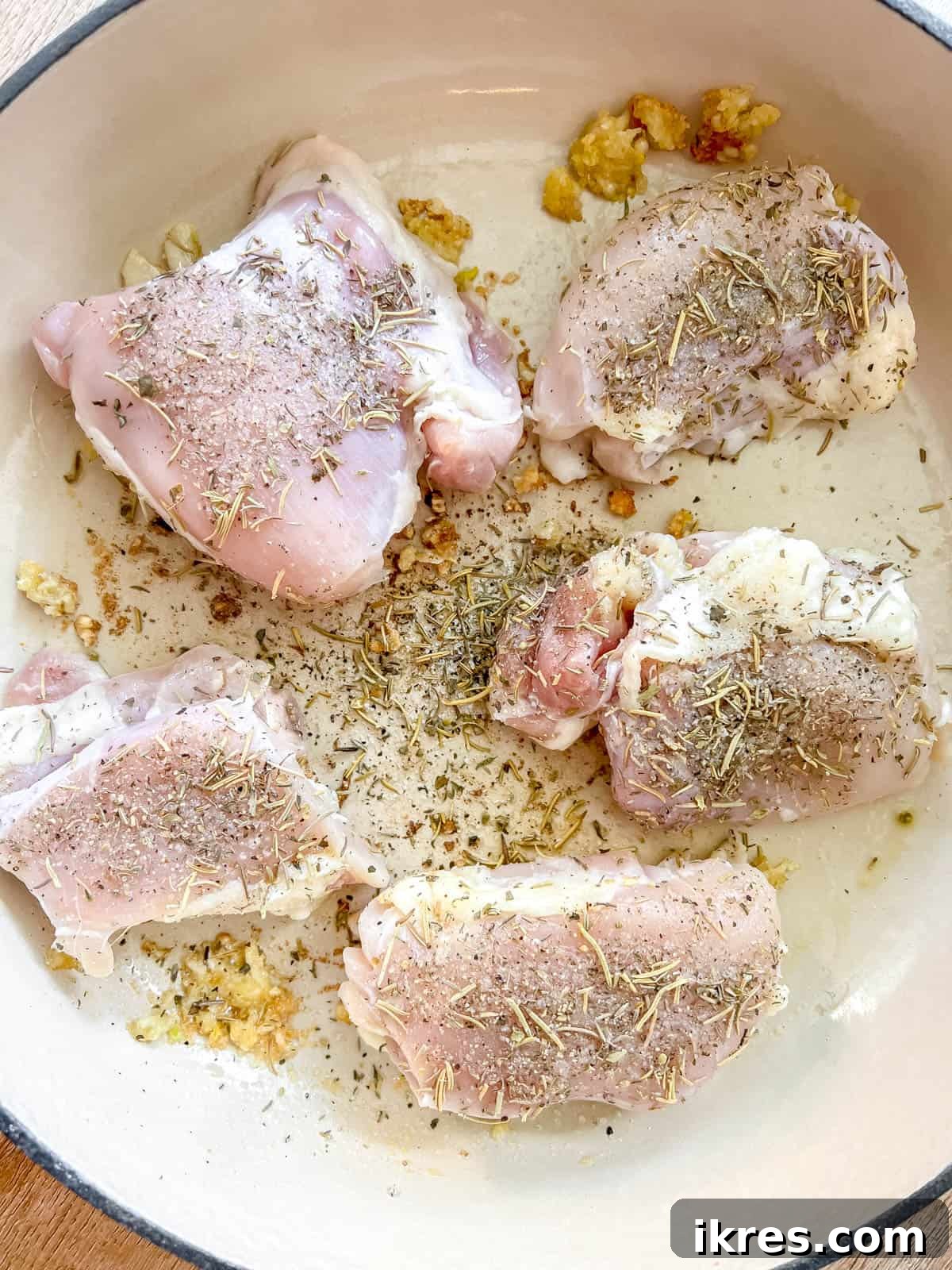 Sticky Maple Peach Chicken Thighs in a Dutch Oven 7 Chicken thighs added to a pan.