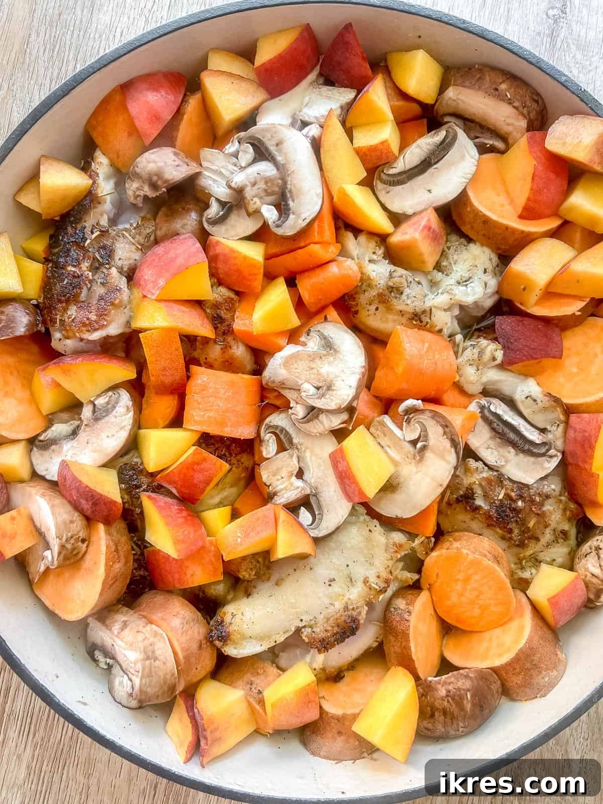 Sticky Maple Peach Chicken Thighs in a Dutch Oven 8 All the fruits and veggies added to the pan.