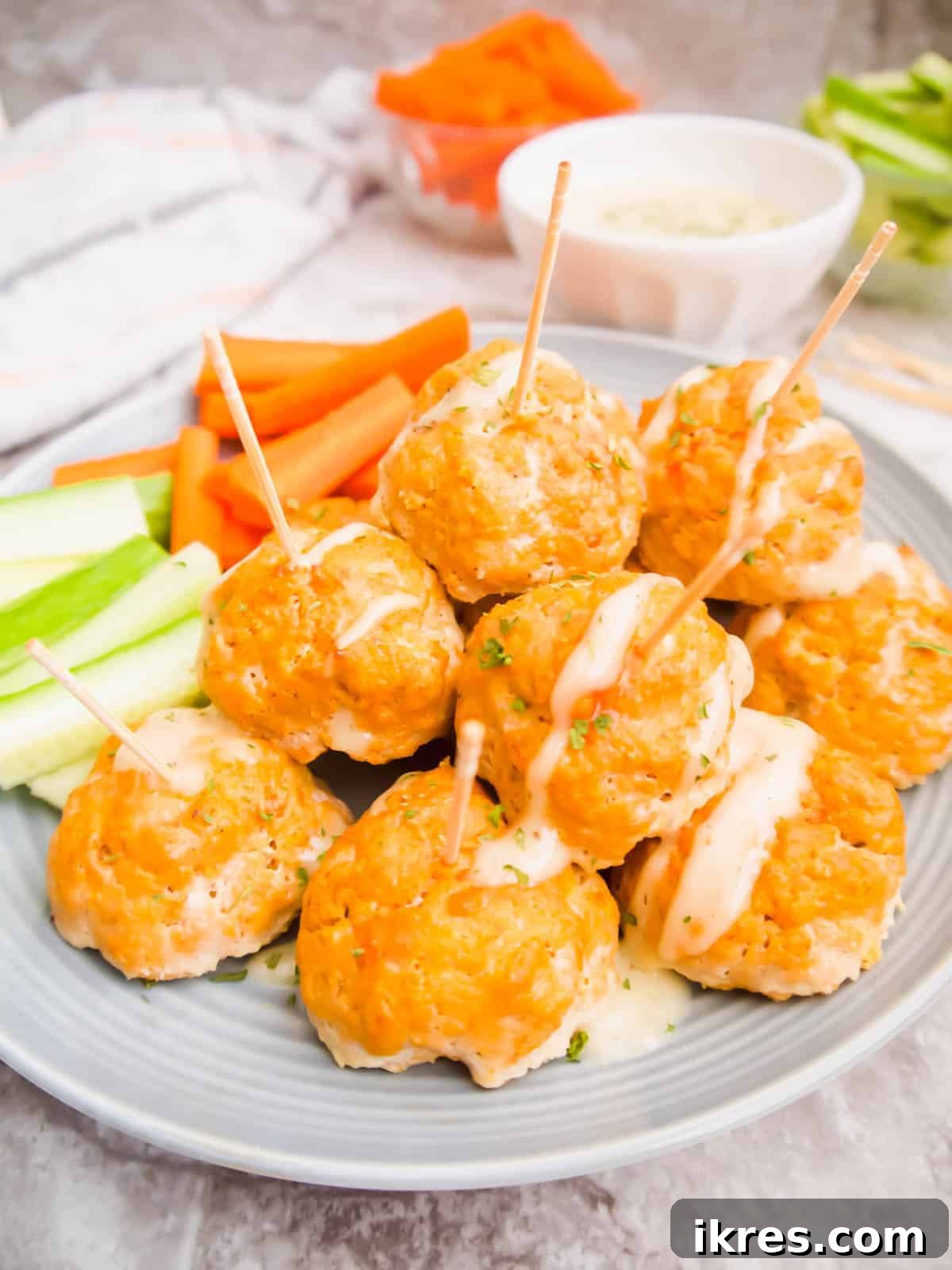 Guilt-Free Buffalo Turkey Meatballs: Your Paleo Whole30 Favorite 2 A plate of healthy buffalo turkey meatballs with toothpicks in each one, ready to be served as an appetizer.