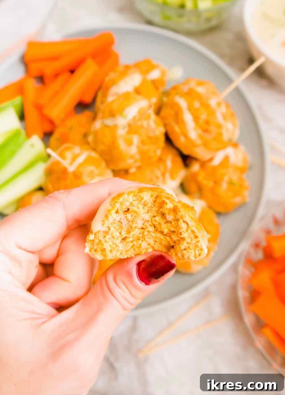 Guilt-Free Buffalo Turkey Meatballs: Your Paleo Whole30 Favorite 8 A bite taken out of a Healthy Buffalo Turkey Meatball, showing its juicy interior and crispy exterior.