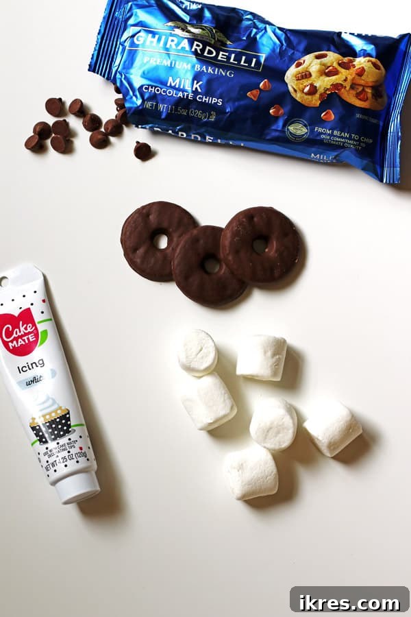 Pilgrim Hat Thanksgiving Treats 3 All the necessary ingredients for Pilgrim Hat Cookies laid out on a white surface: Keebler cookies, large marshmallows, chocolate chips, and a tube of decorating frosting.