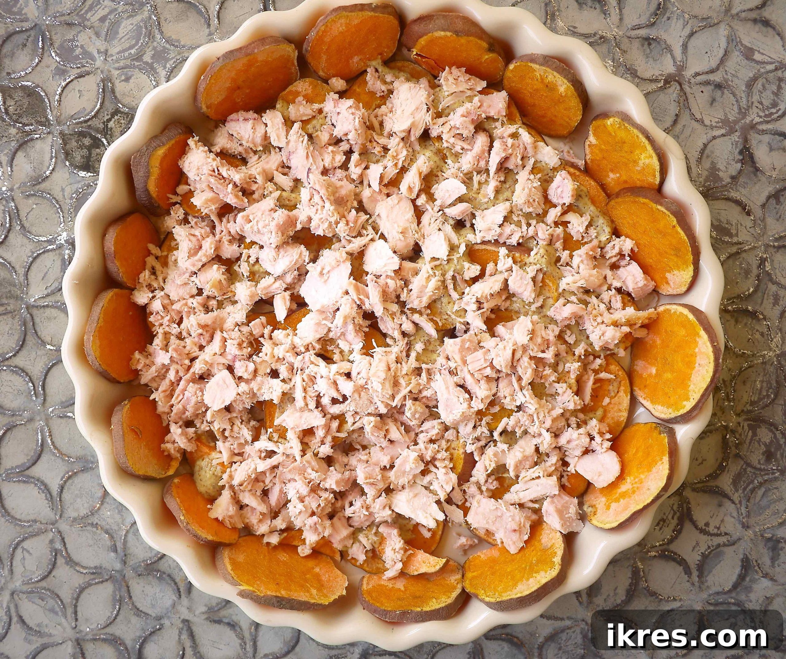 Flavorful French Tuna and Tomato Quiche on a Golden Potato Crust 5 Flaked canned tuna distributed over the mustard layer on the sweet potato crust.