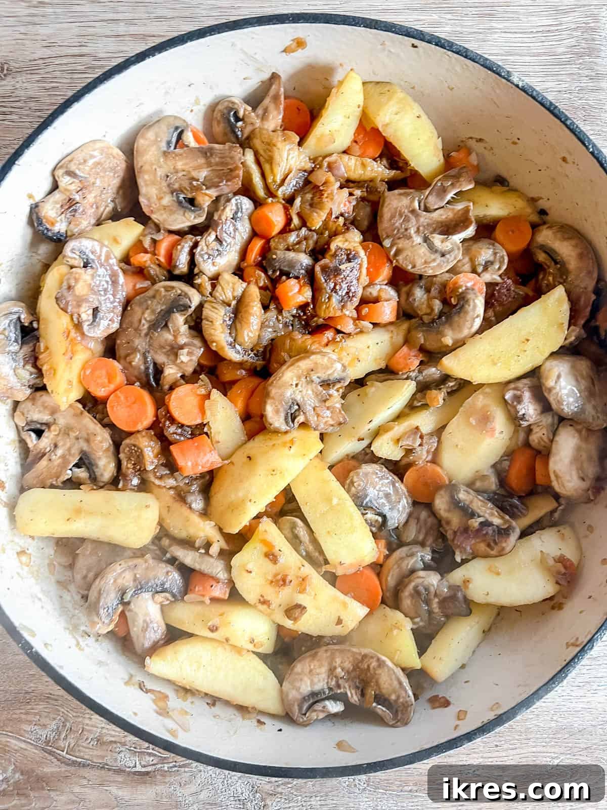 Sweet and Savory Dutch Oven Pork Tenderloin with Apples and Figs 6 Apples, carrots, mushrooms, and figs added to a Dutch oven with cooked aromatics.