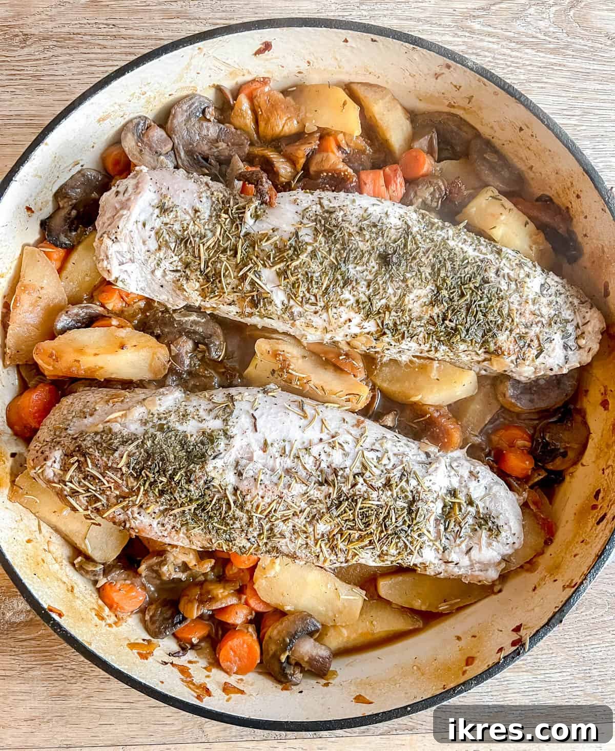 Sweet and Savory Dutch Oven Pork Tenderloin with Apples and Figs 8 Cooked Pork Tenderloin with Apples and Figs in a Dutch oven, ready to serve.