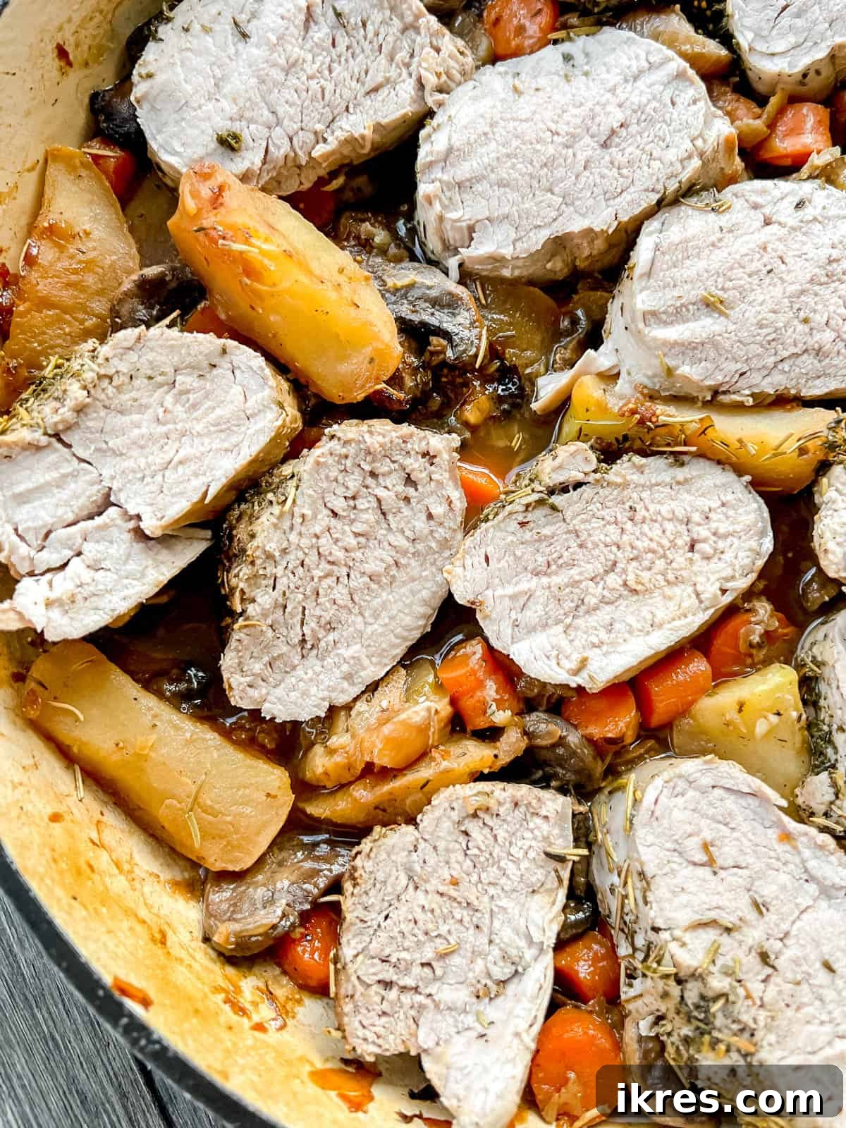 Sweet and Savory Dutch Oven Pork Tenderloin with Apples and Figs 9 Close-up of fig pork tenderloin in a Dutch oven with rich, saucy vegetables.