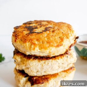 Three healthy burger patties stacked on top of each other.
