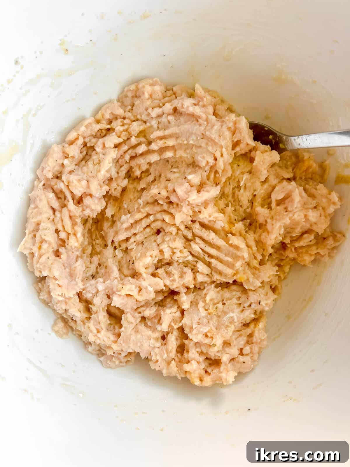 Ground chicken burger mixture in a bowl, ready to be formed into patties.