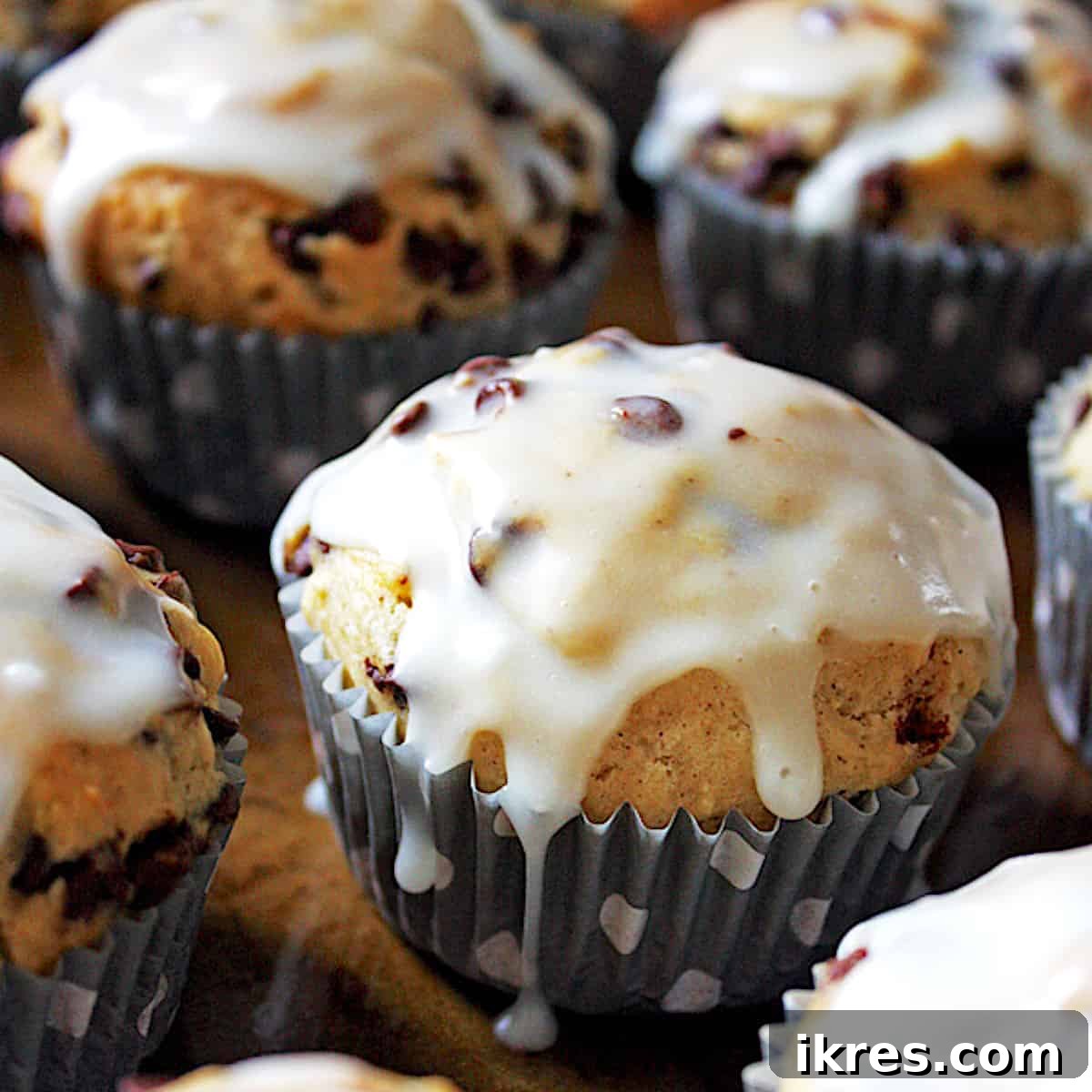 Delicious banana nut chocolate chip muffins with a sweet glaze dripping down.
