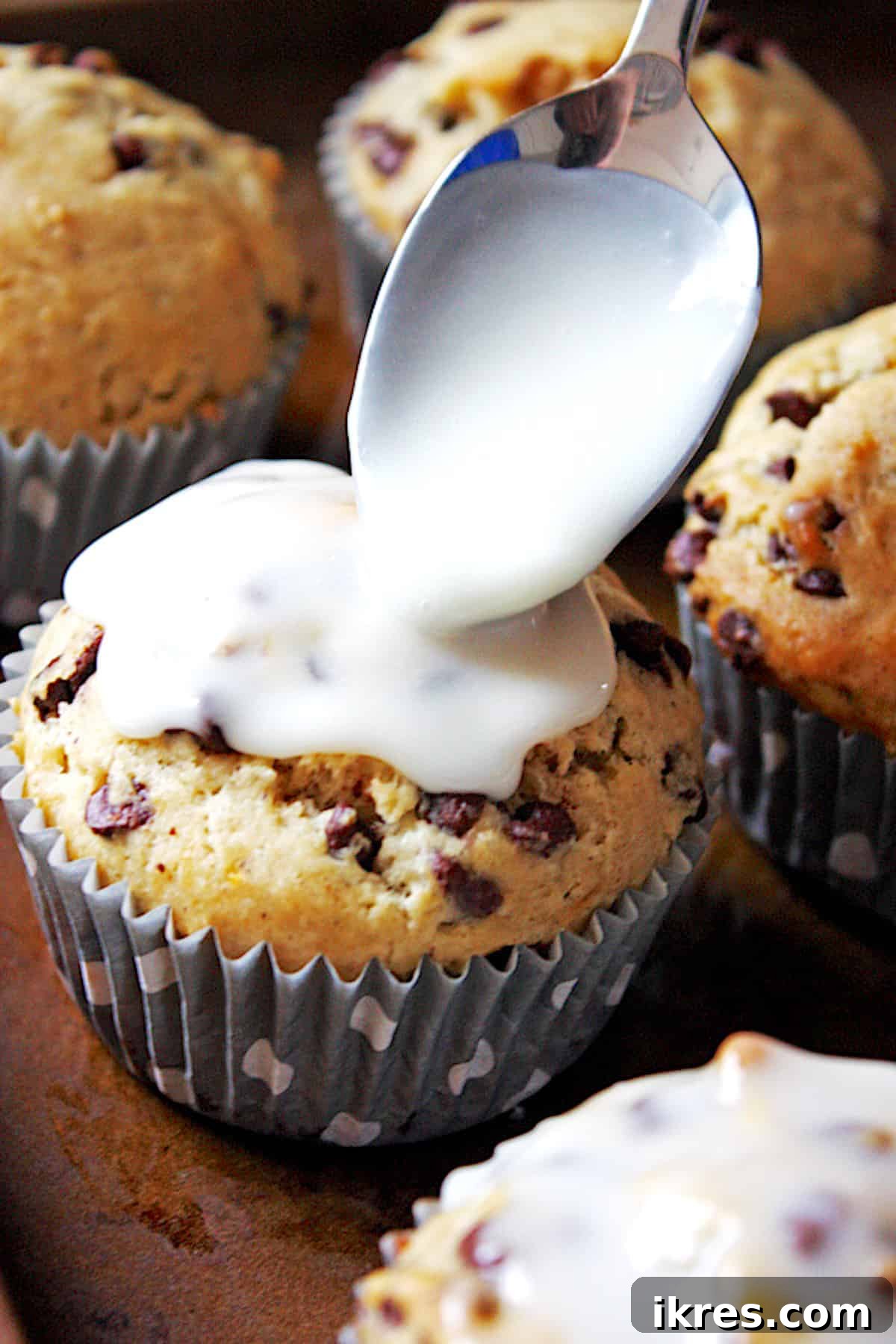 Close-up of fully glazed banana nut chocolate chip muffins.