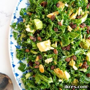 Chopped kale salad with avocado and lemon dressing in a large plate.
