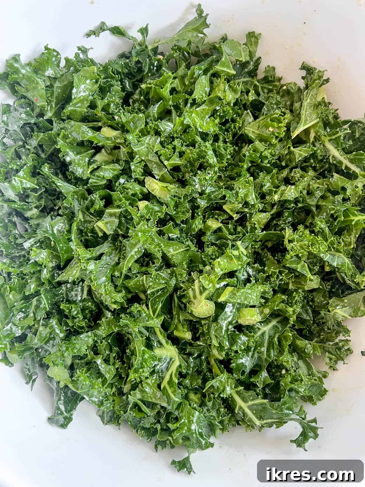 Lemon-Kissed Kale Avocado Salad 7 Massaged kale salad with lemon dressing resting in a bowl, looking tender, glossy, and infused with flavor.