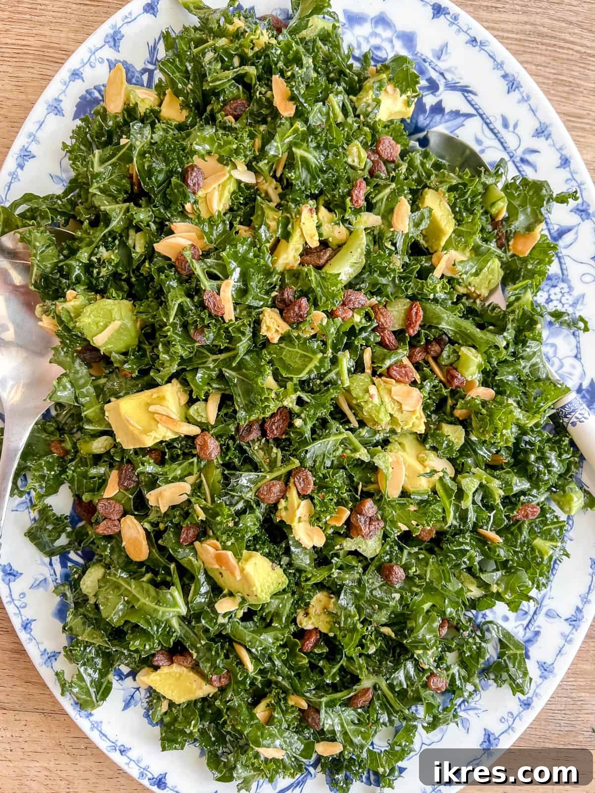 Lemon-Kissed Kale Avocado Salad 9 The finished chopped kale and avocado salad with lemon dressing, thoroughly mixed and ready to be served in a bowl.