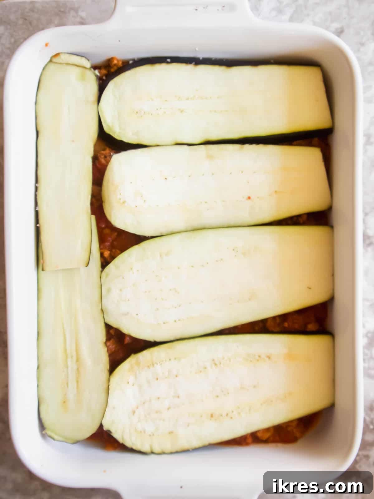 Hearty Turkey and Summer Vegetable Bake 6 A meticulously arranged layer of salted eggplant slices placed over the meat sauce in the baking pan.