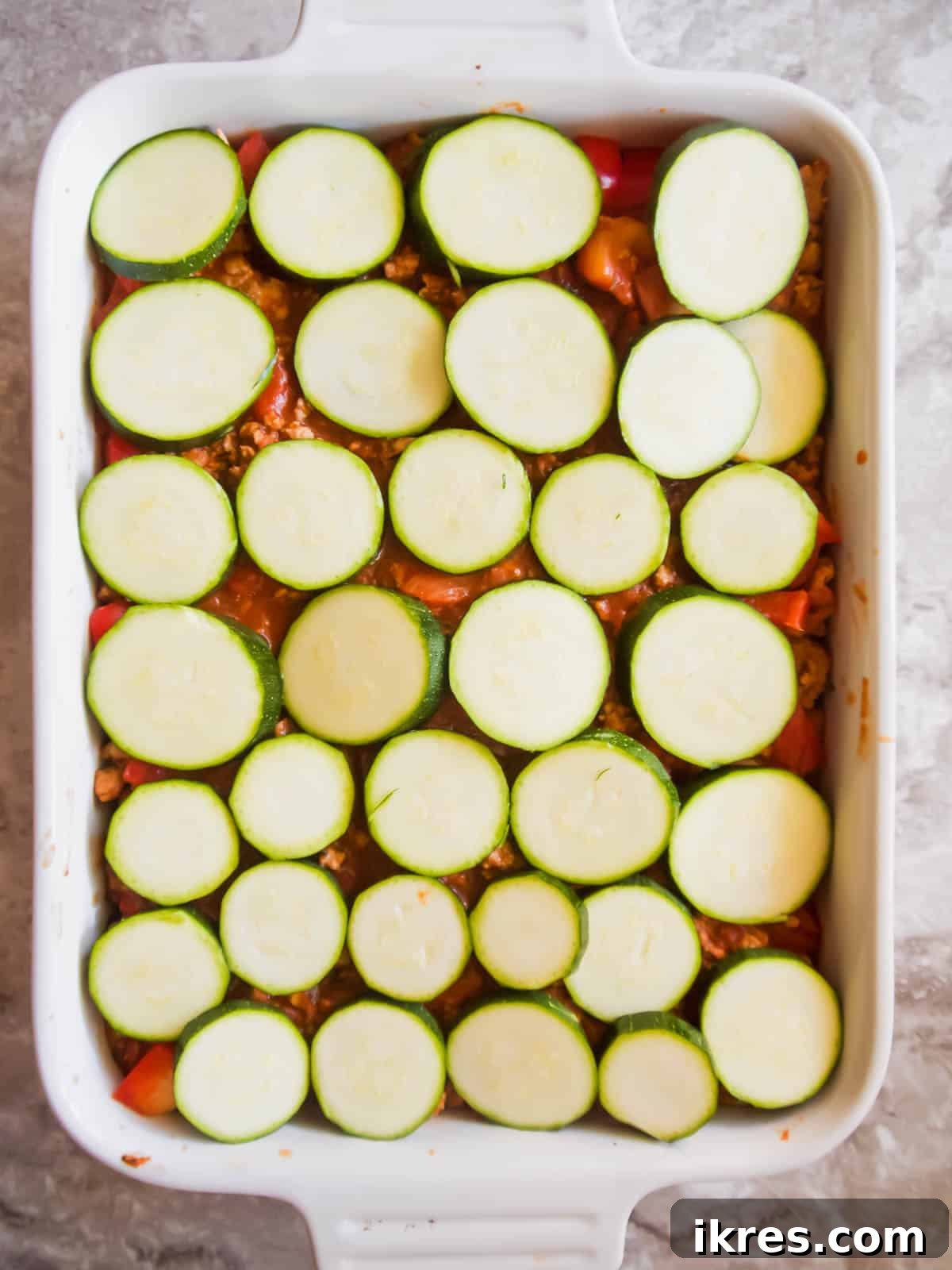 Hearty Turkey and Summer Vegetable Bake 8 The final vegetable layer of sliced zucchini placed over the meat sauce in the casserole pan.