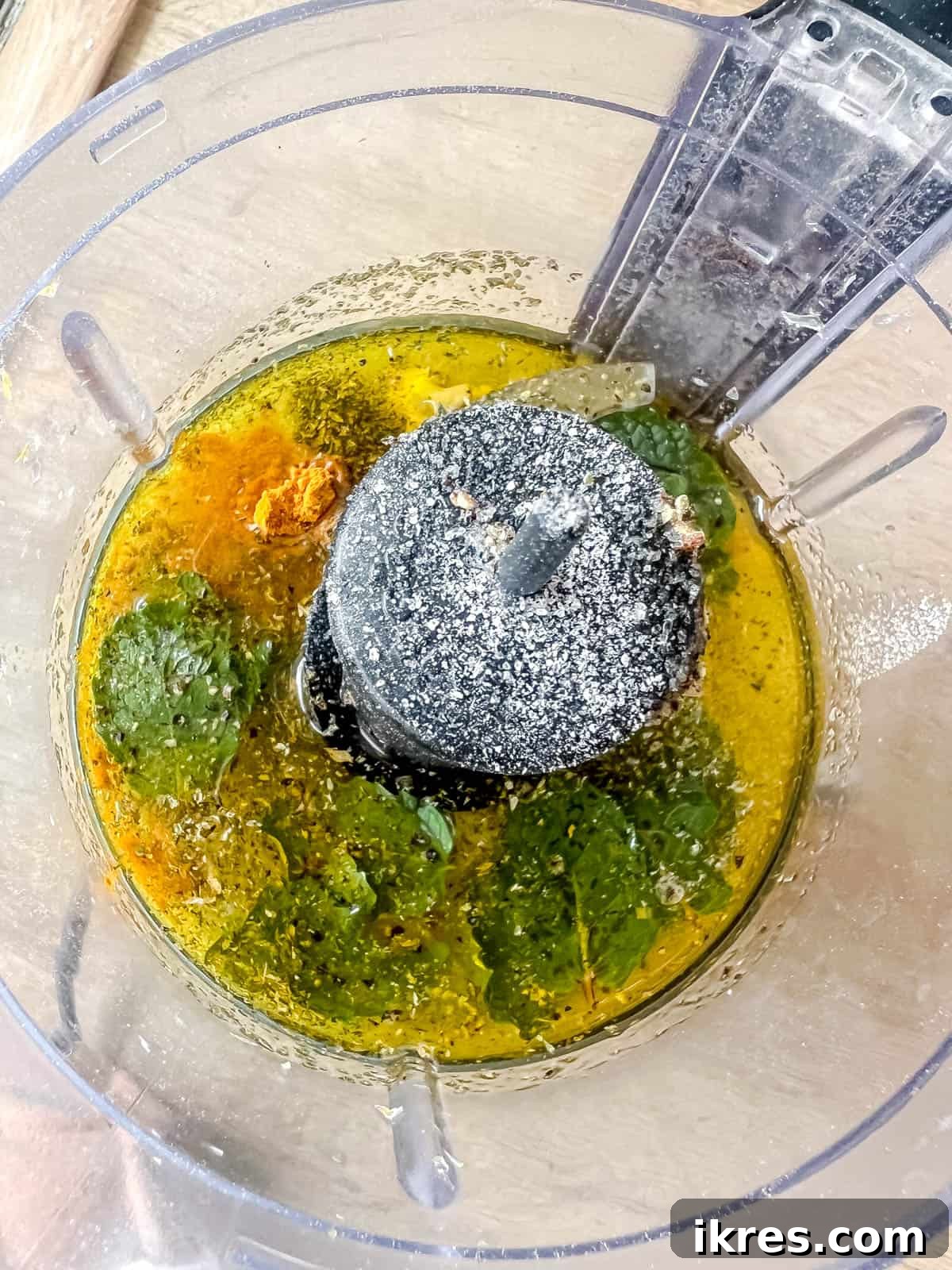 All ingredients for the lemon turmeric mint dressing placed into a food processor, ready for blending.