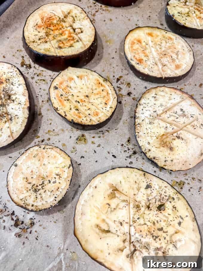 Vibrant Grilled Chicken Greek Salad 9 Grilled eggplant slices resting on a pan, having cooled down after roasting.