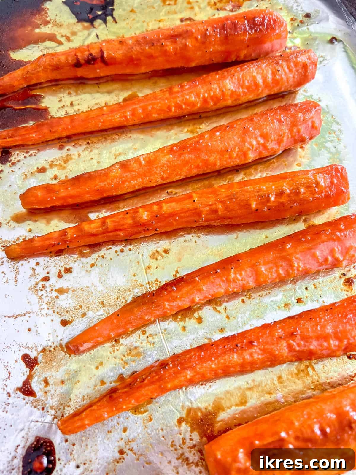 Sunshine Maple Glazed Carrots 7 Close-up of perfectly roasted turmeric maple glazed carrots in a serving bowl.