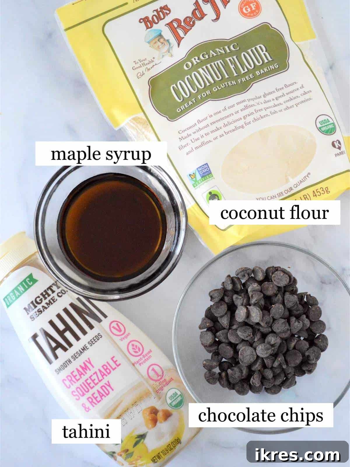 Easy No-Bake Power Bites 3 A selection of wholesome ingredients for no-bake energy bites, neatly arranged and labeled on a rustic surface.