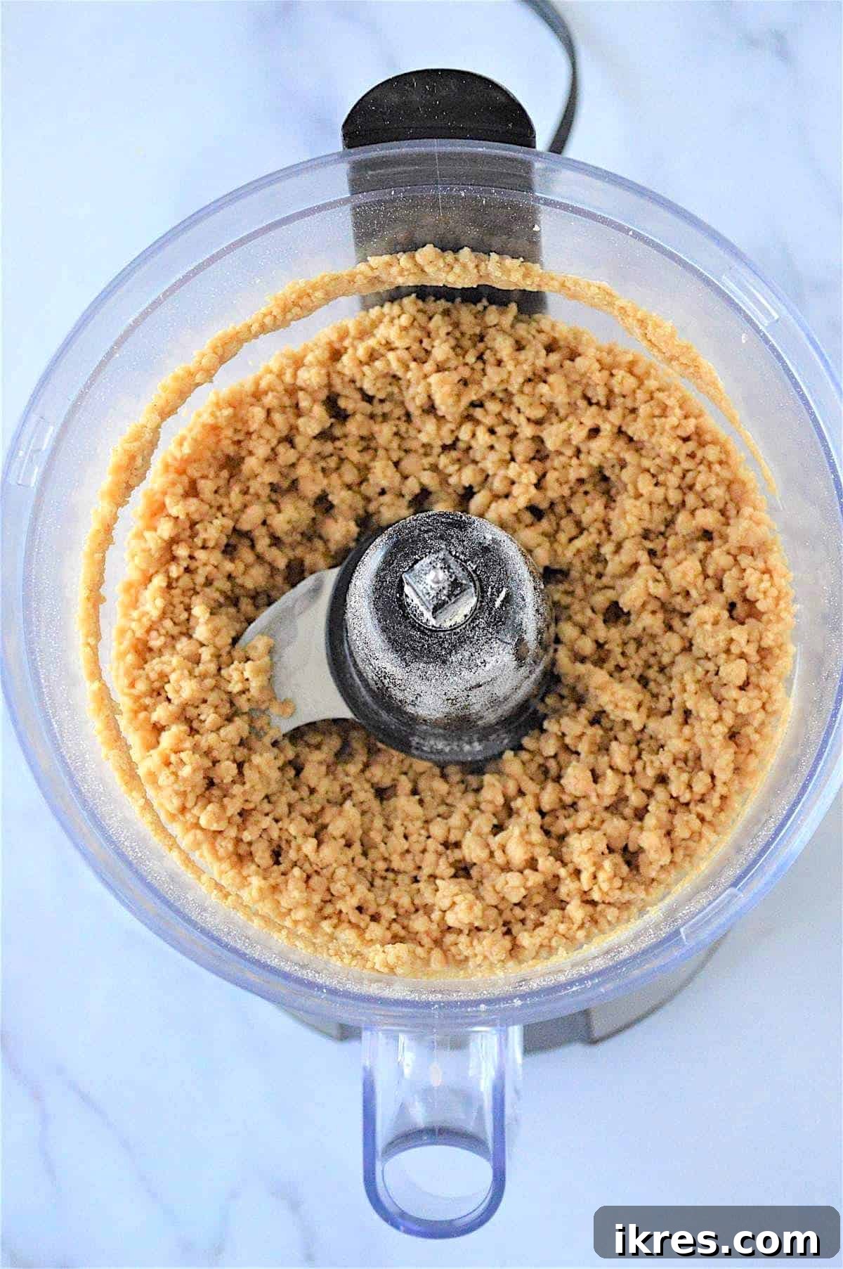 Easy No-Bake Power Bites 6 The no bake energy ball dough forming a crumbly yet moldable texture in a food processor, indicating readiness for the next step.