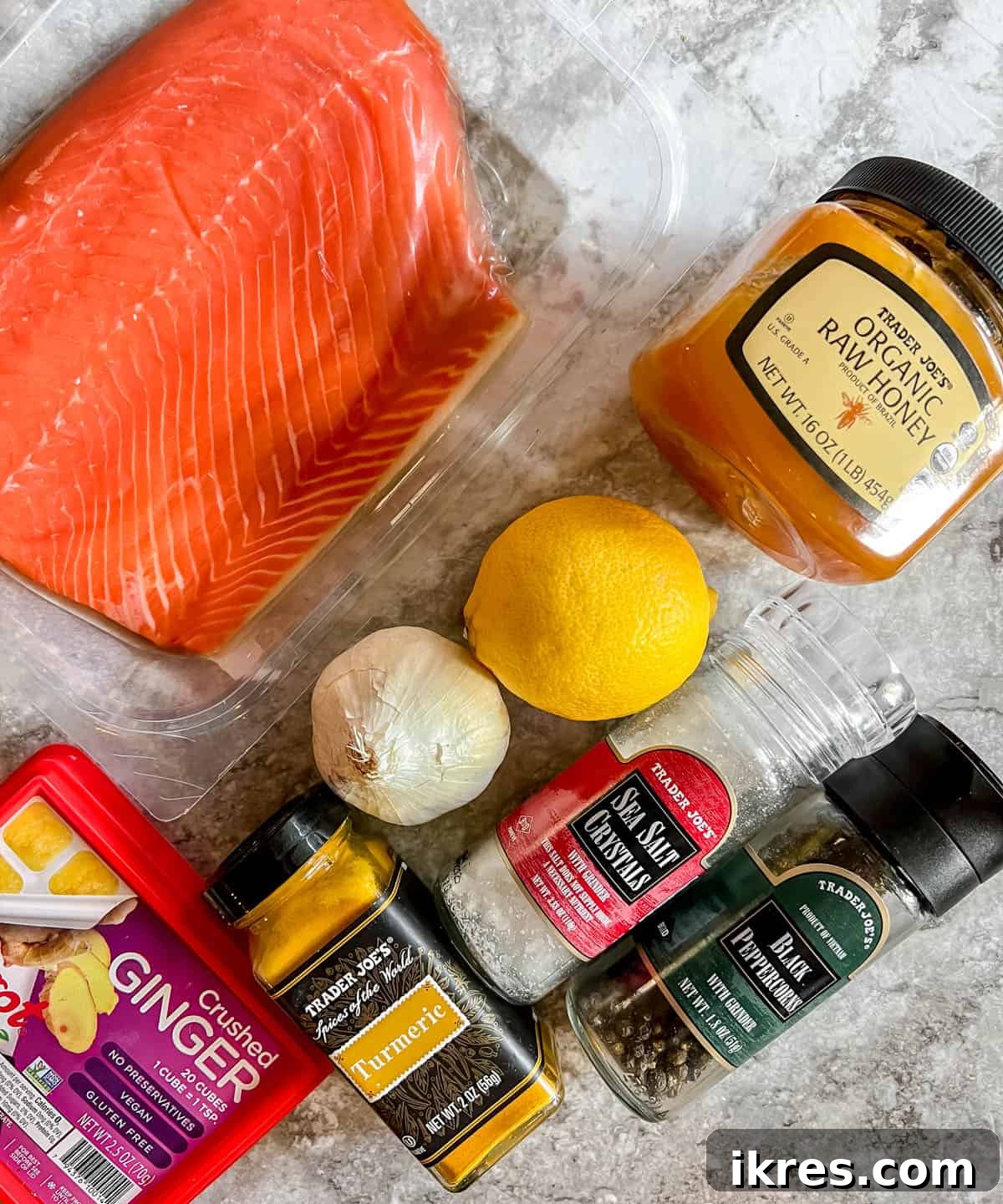 Ingredients for lemon ginger turmeric salmon, including lemon, ginger, turmeric, honey, and salmon fillets.