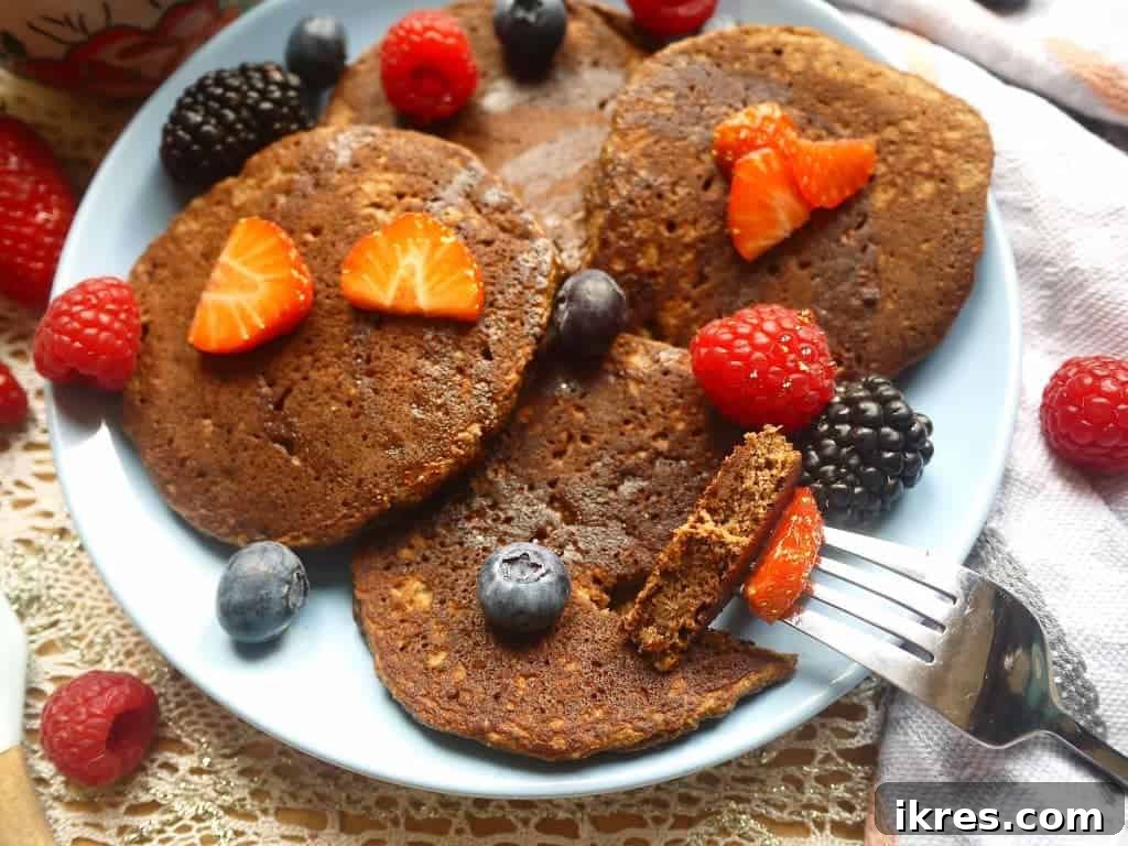 Enjoy these Chocolatey Cocoa Paleo Pancakes (GF) with your favorite toppings like maple syrup and berries. | Perchance to Cook, www.perchancetocook.com