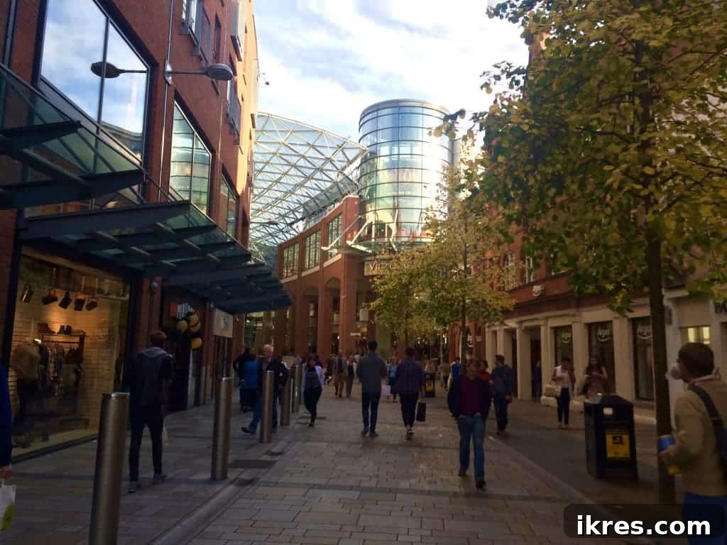 The striking glass dome and modern interior of Victoria Square Shopping Centre, a hub of retail in Belfast.