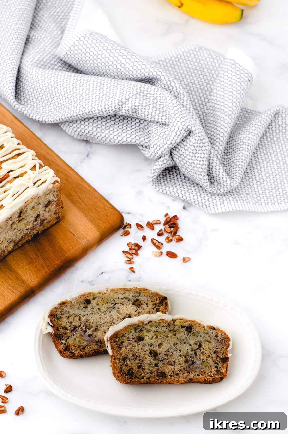 Buttermilk Banana Bread Perfection 11 Delicious slices of homemade buttermilk banana bread arranged artfully on a white plate, inviting a bite.
