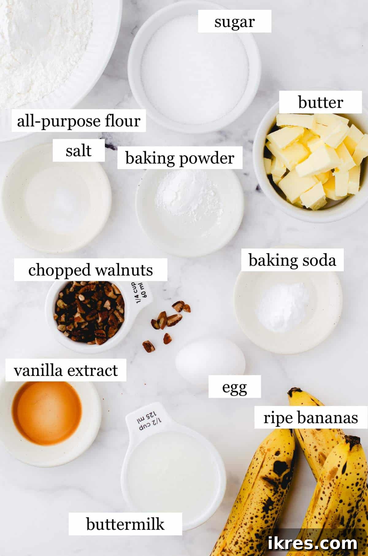 Buttermilk Banana Bread Perfection 3 The eleven essential ingredients for making buttermilk banana bread, neatly arranged and labeled on a kitchen counter.