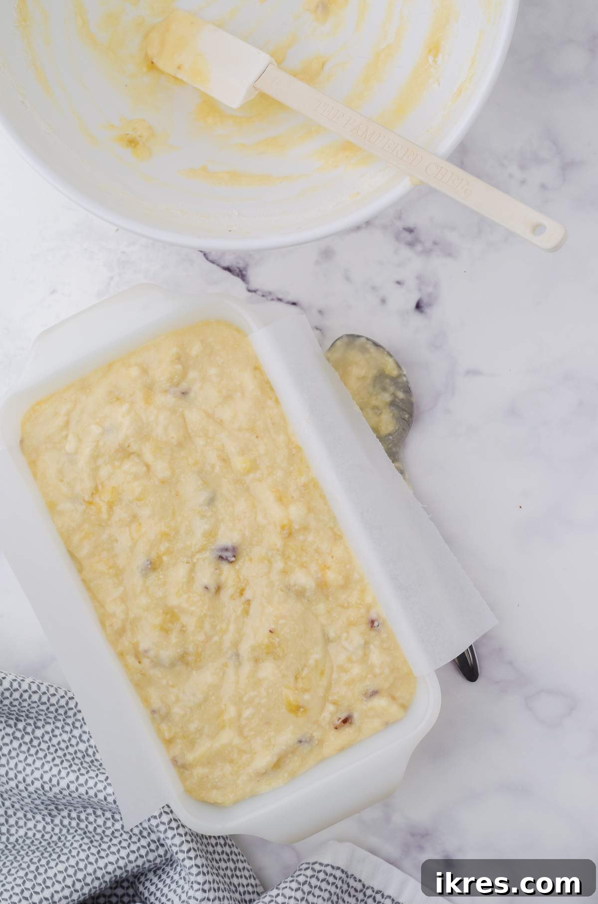Buttermilk Banana Bread Perfection 8 The smooth, golden buttermilk banana bread batter is neatly poured into a loaf pan, awaiting its transformation in the oven.