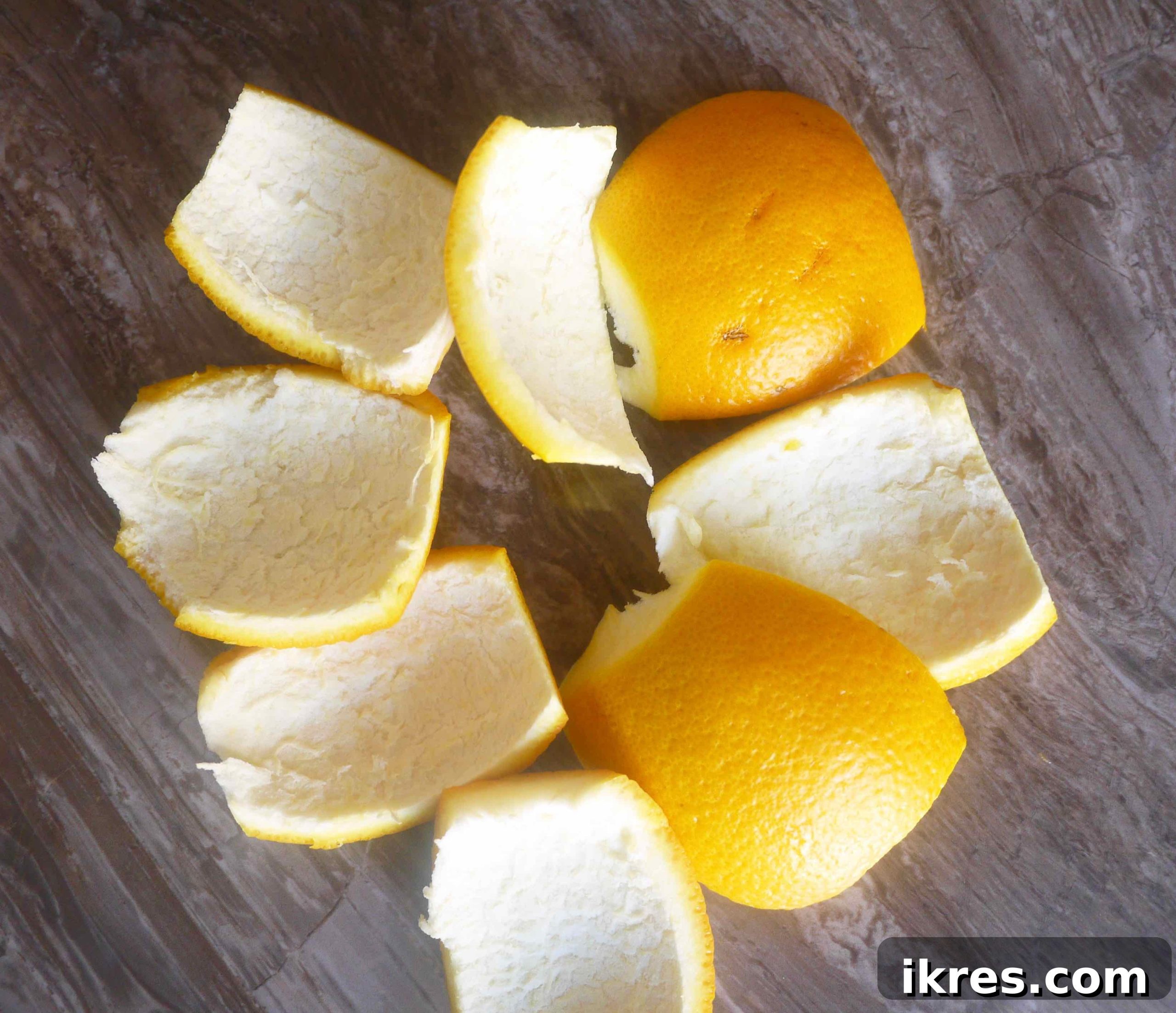 Paleo Honey Candied Orange Peels 4 Orange peels expertly scored into quarters, ready for peeling.