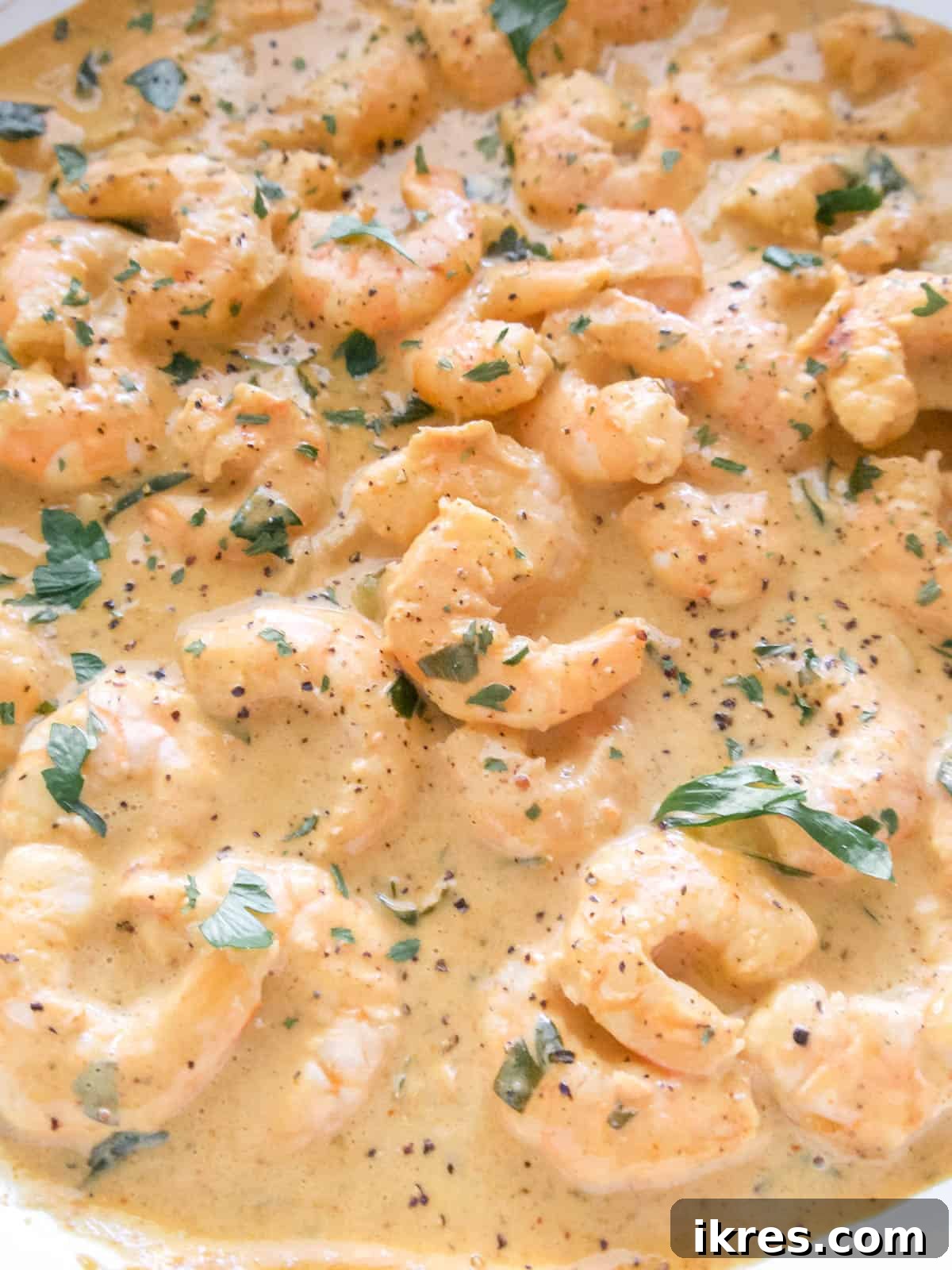 Perfect Paleo Paprika Garlic Shrimp Dinner 6 Shrimp, coconut cream, lemon juice, parsley, and paprika added to the pan with garlic.