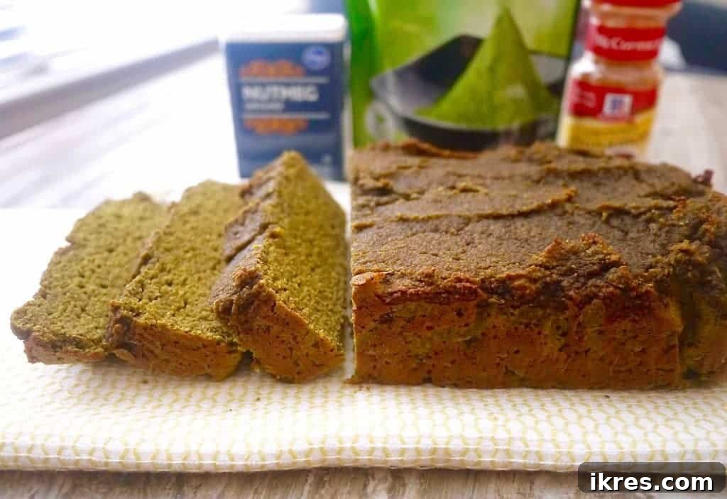 Another angle of the Grain-Free Morning Matcha Loaf presented beautifully with a cup of matcha tea.