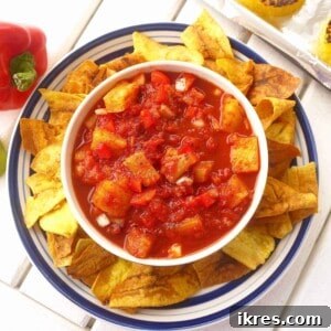 Grilled Pineapple Salsa in a bowl surrounded by crispy tortilla chips.