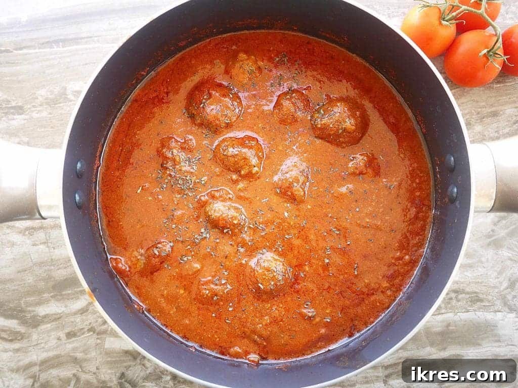 Wholesome Almond Flour Meatballs with Savory Sauce 8 Cooked gluten-free meatballs swimming in a rich marinara sauce after simmering for hours.