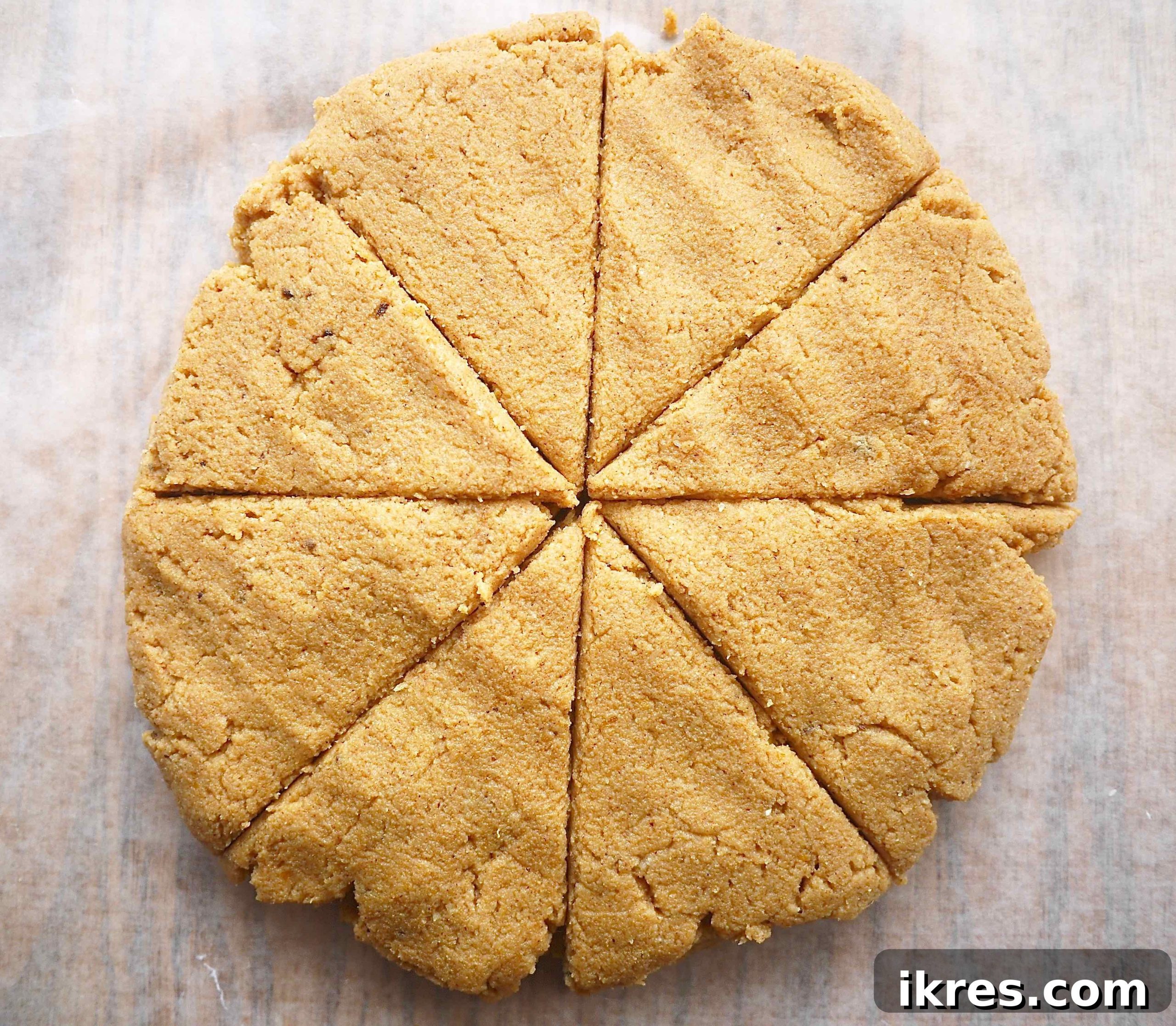 Gluten-Free Paleo Pumpkin Scones 4 Pumpkin scone dough flattened into a circle on a cutting board, ready to be cut.
