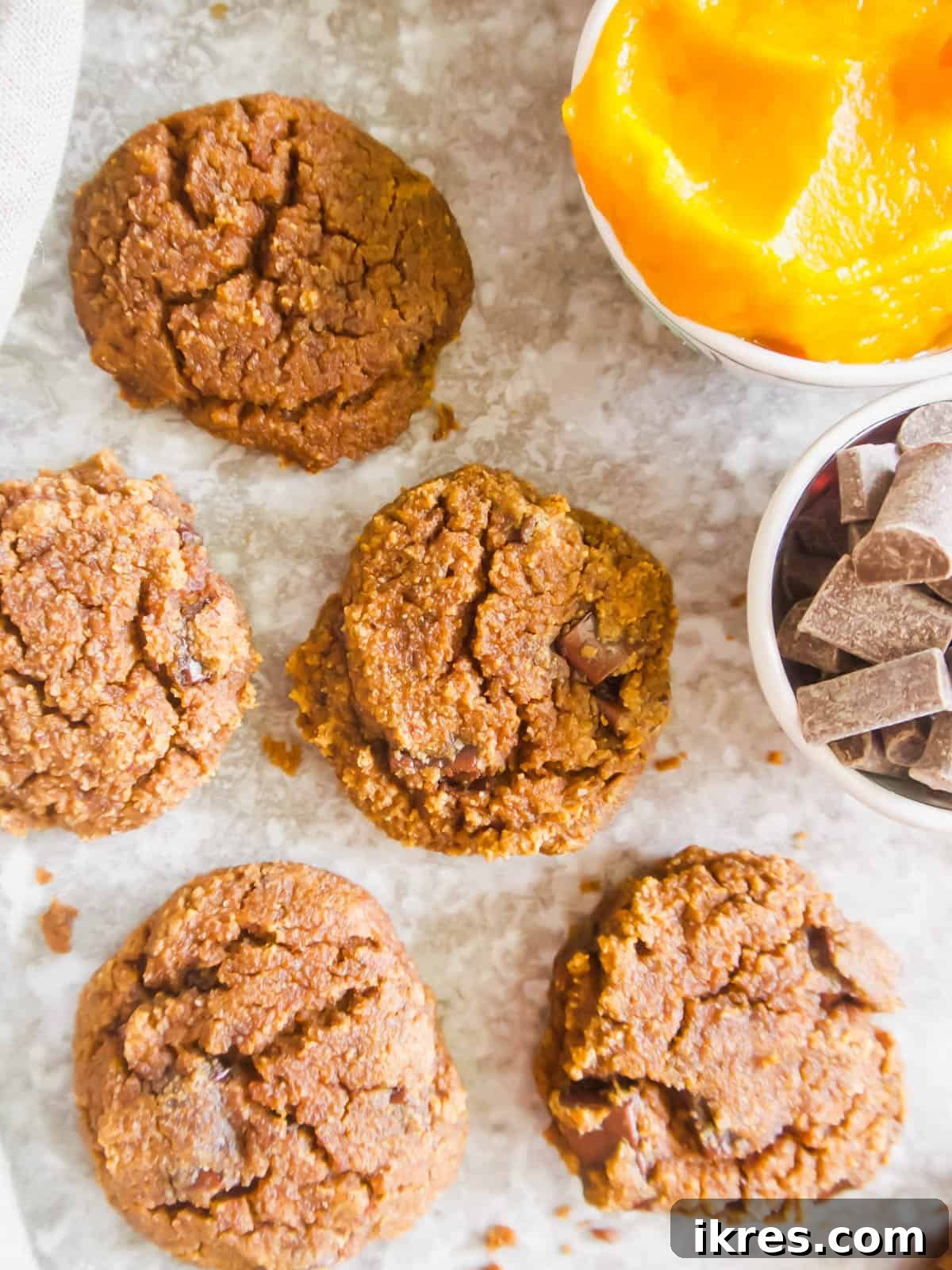Grain-Free Pumpkin Spice Cookies 5 Golden-brown healthy pumpkin chocolate chip cookies after baking, cooling on a wire rack.
