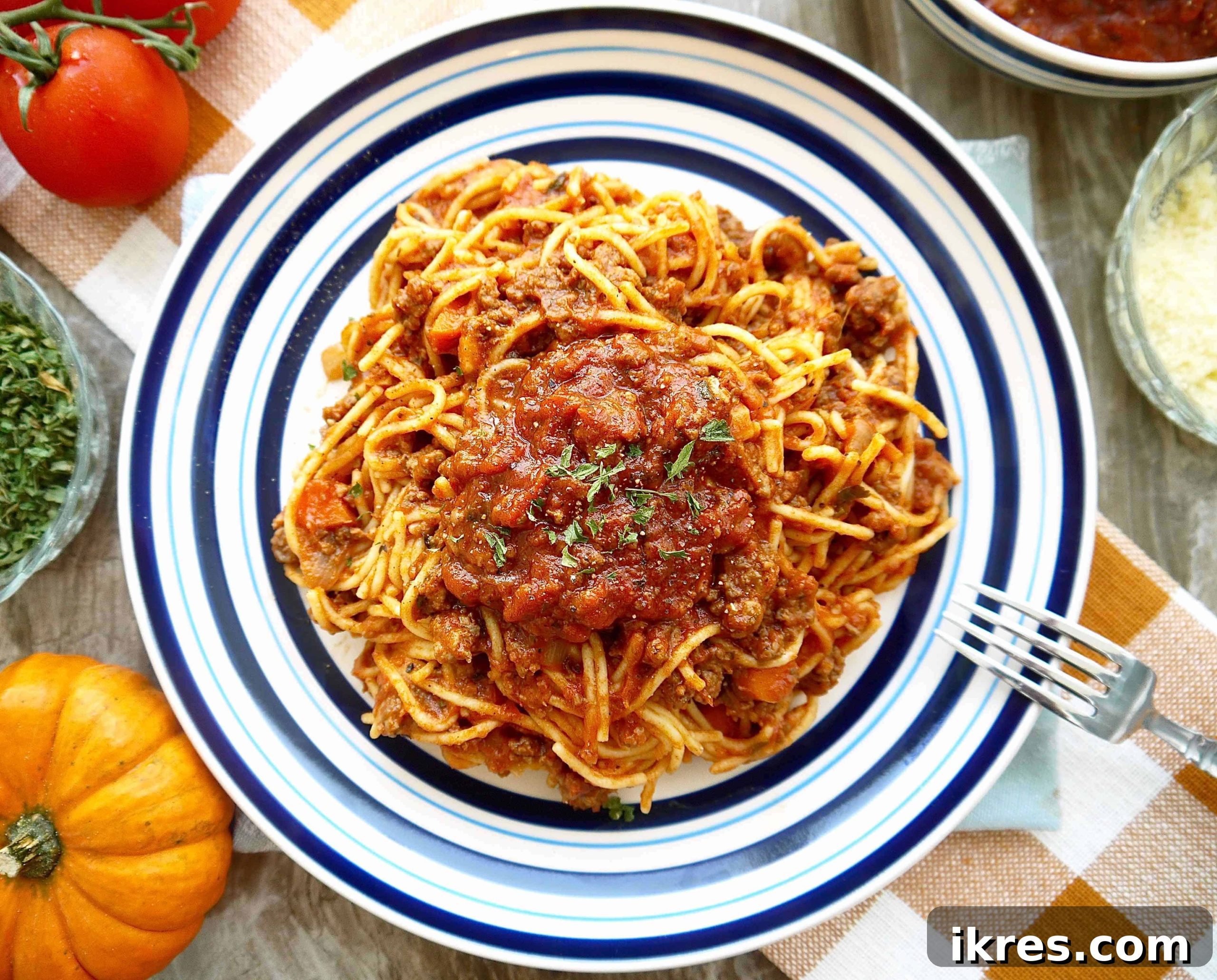 Velvety Pumpkin Ragù 2 A vibrant plate of pumpkin bolognese, rich with meat and sauce, garnished with fresh herbs, ready to be enjoyed.