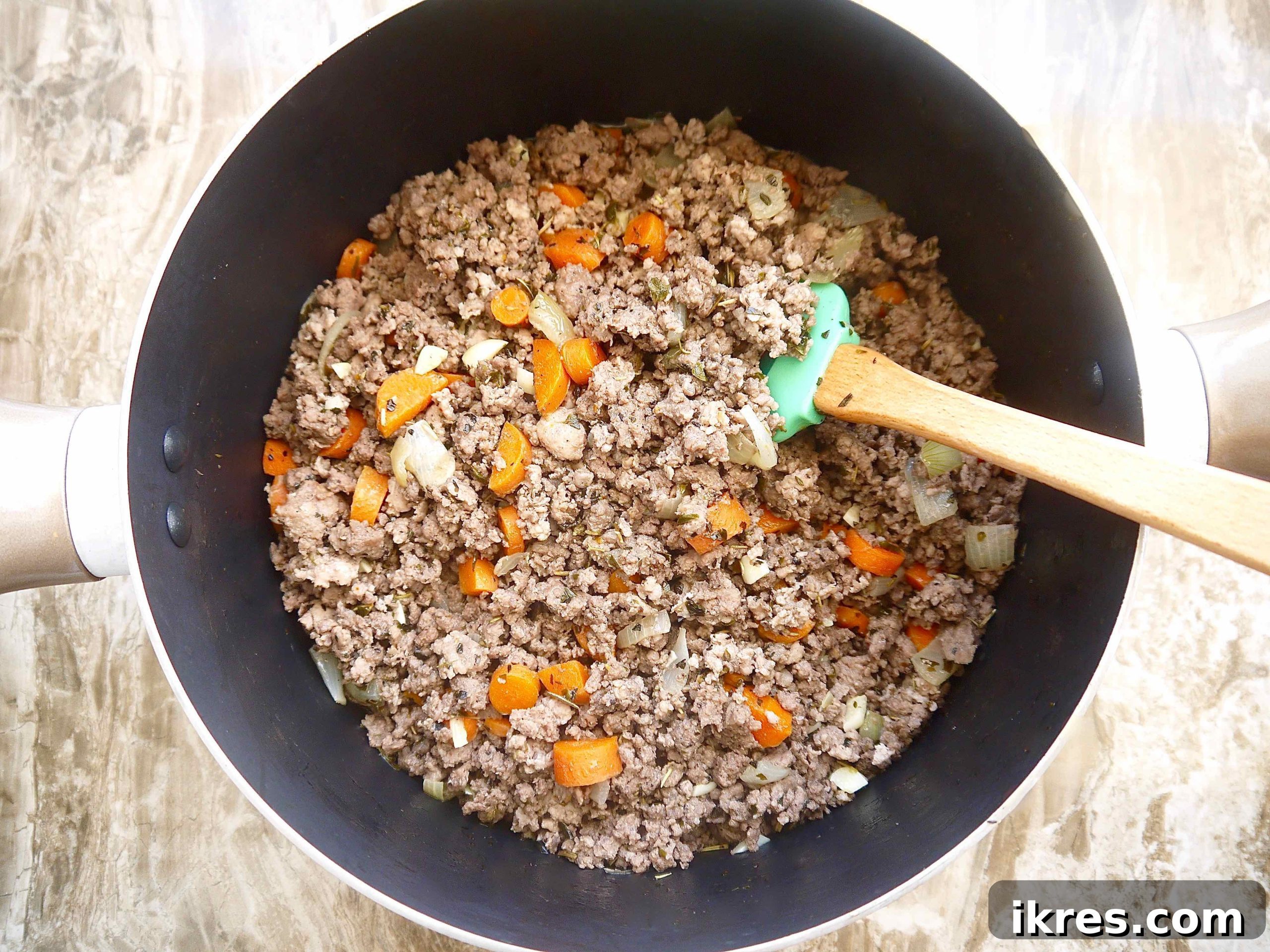 Velvety Pumpkin Ragù 4 Sautéed onions, carrots, and browned ground beef and pork cooking together in a large pot, forming the aromatic base of the bolognese.