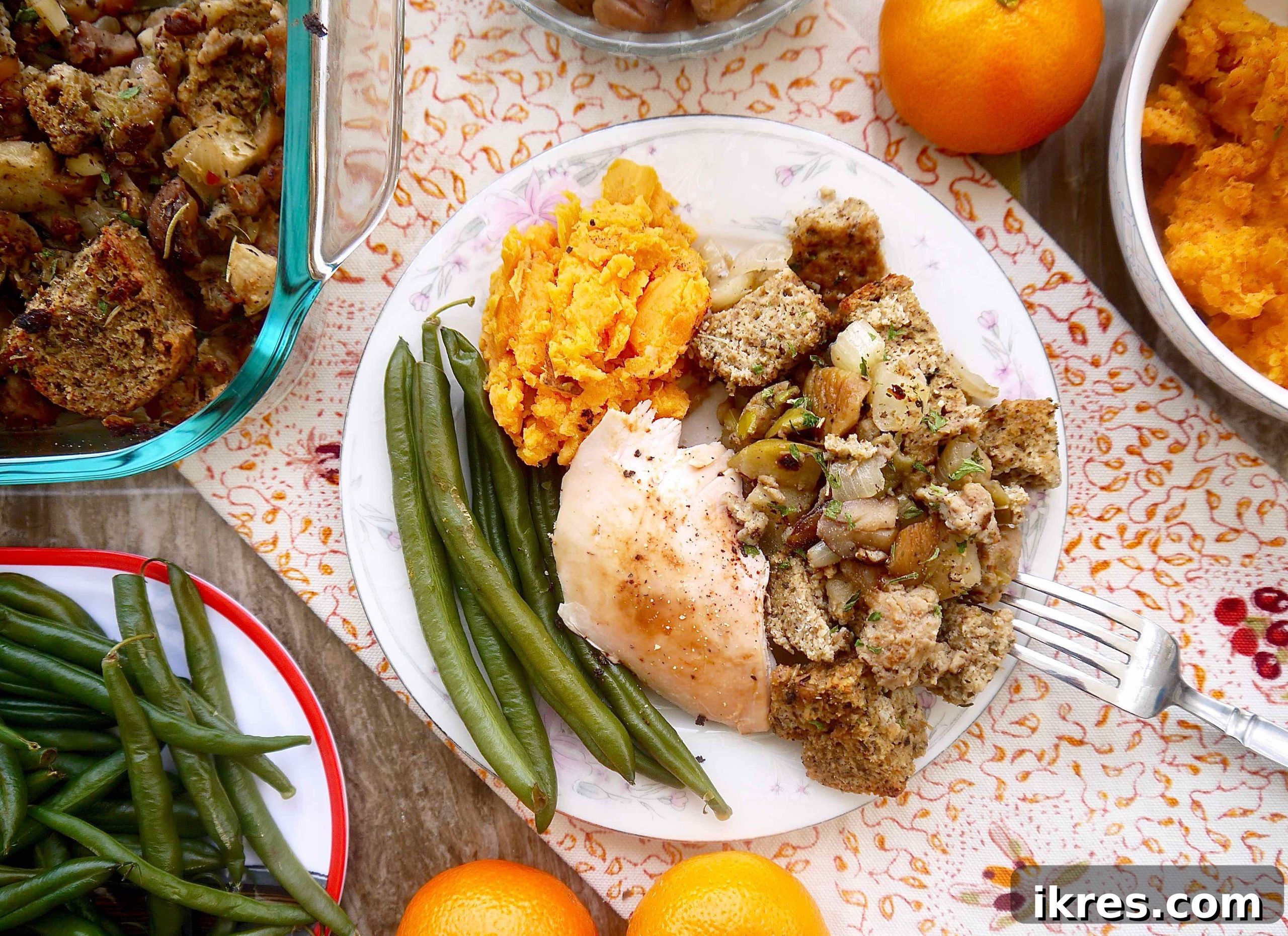 Wholesome Paleo Stuffing with Sausage, Apple and Chestnut Medley 3 Paleo sausage stuffing on a plate with roasted turkey, creamy mashed potatoes and vibrant green beans.