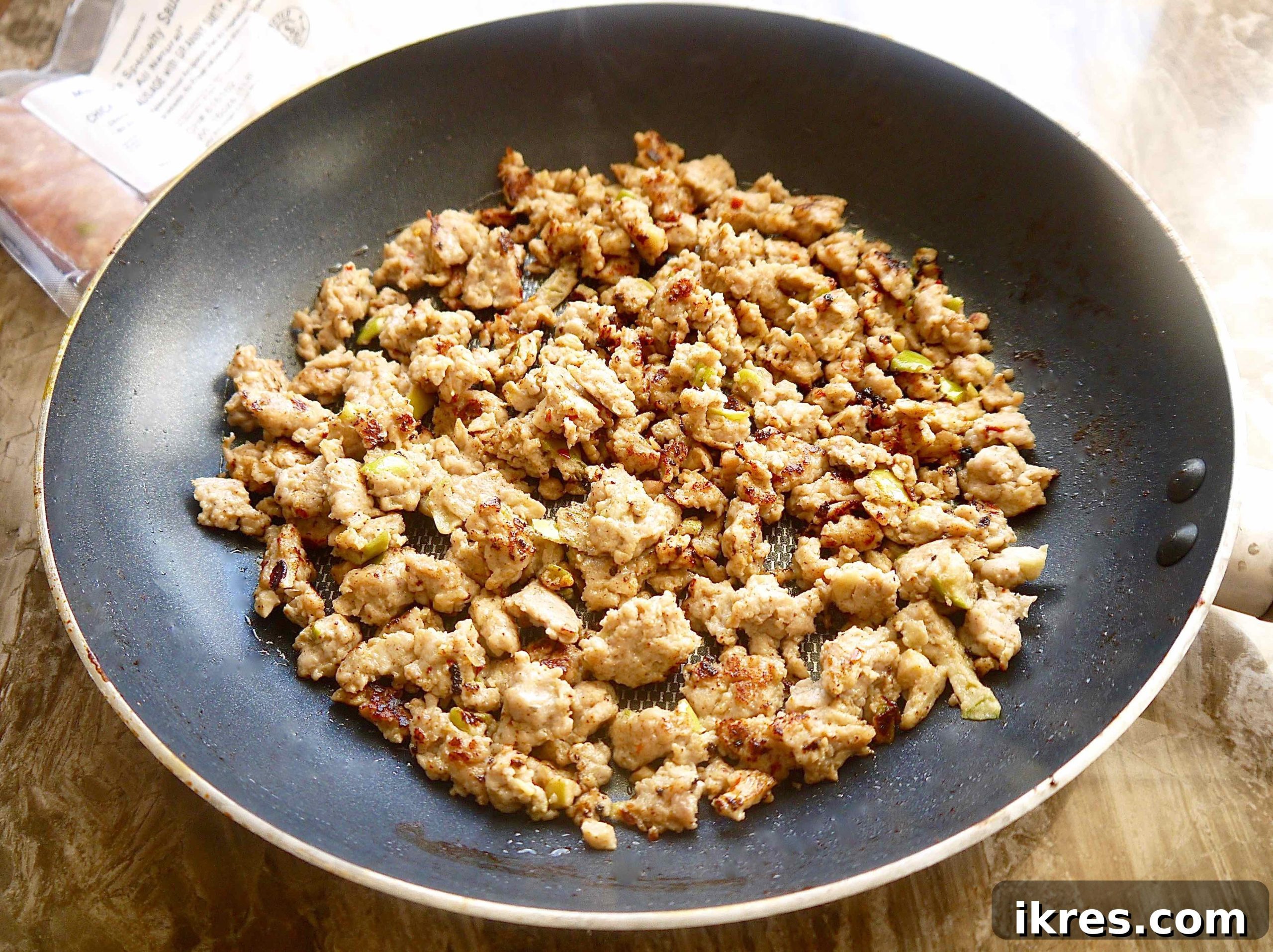 Wholesome Paleo Stuffing with Sausage, Apple and Chestnut Medley 5 Cooked savory sausage in a pan, browned and ready for the next step.