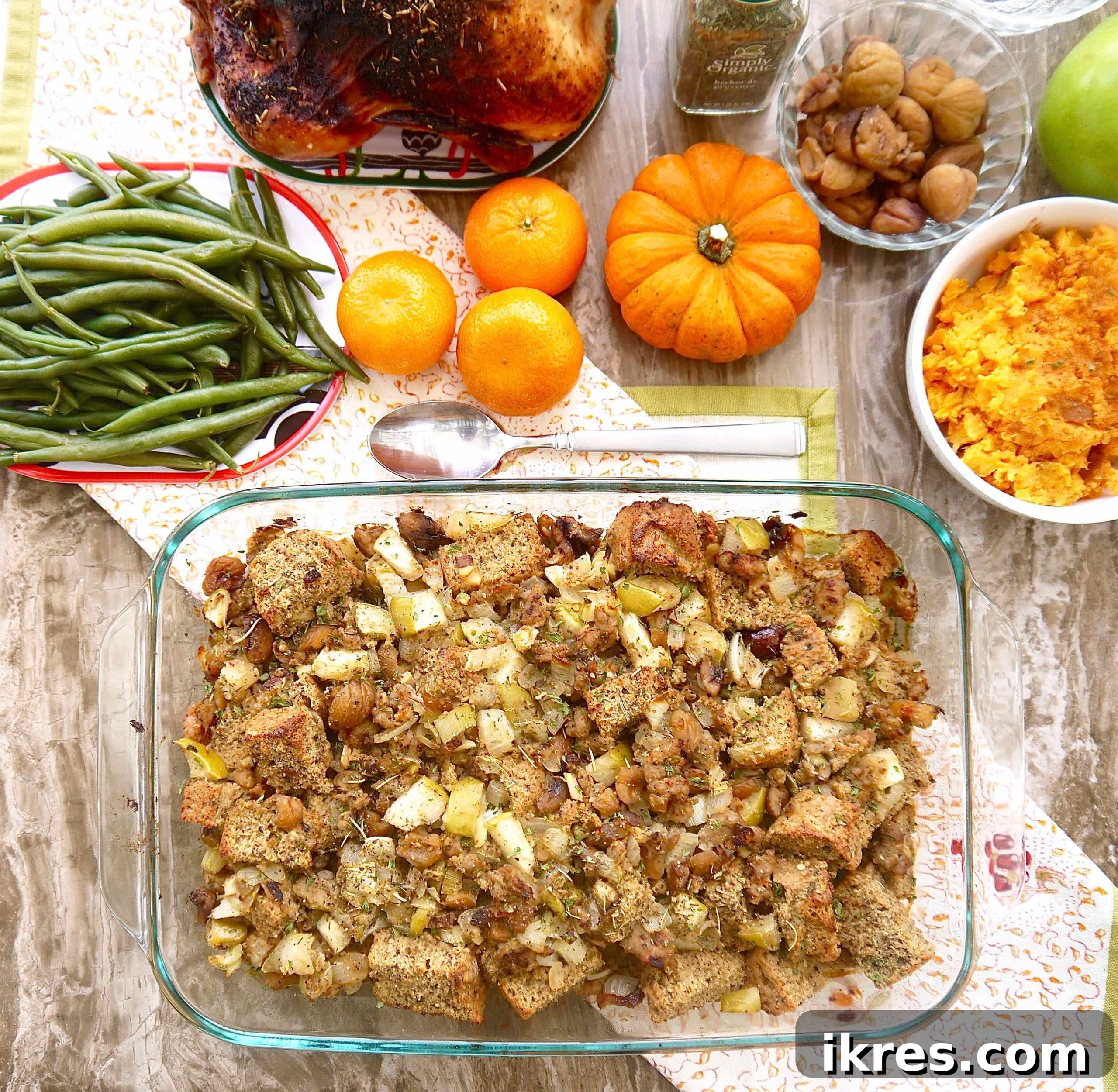 Wholesome Paleo Stuffing with Sausage, Apple and Chestnut Medley 10 Gluten-free chestnut stuffing with sausage in a large pan, surrounded by other delicious side dishes on a festive table.