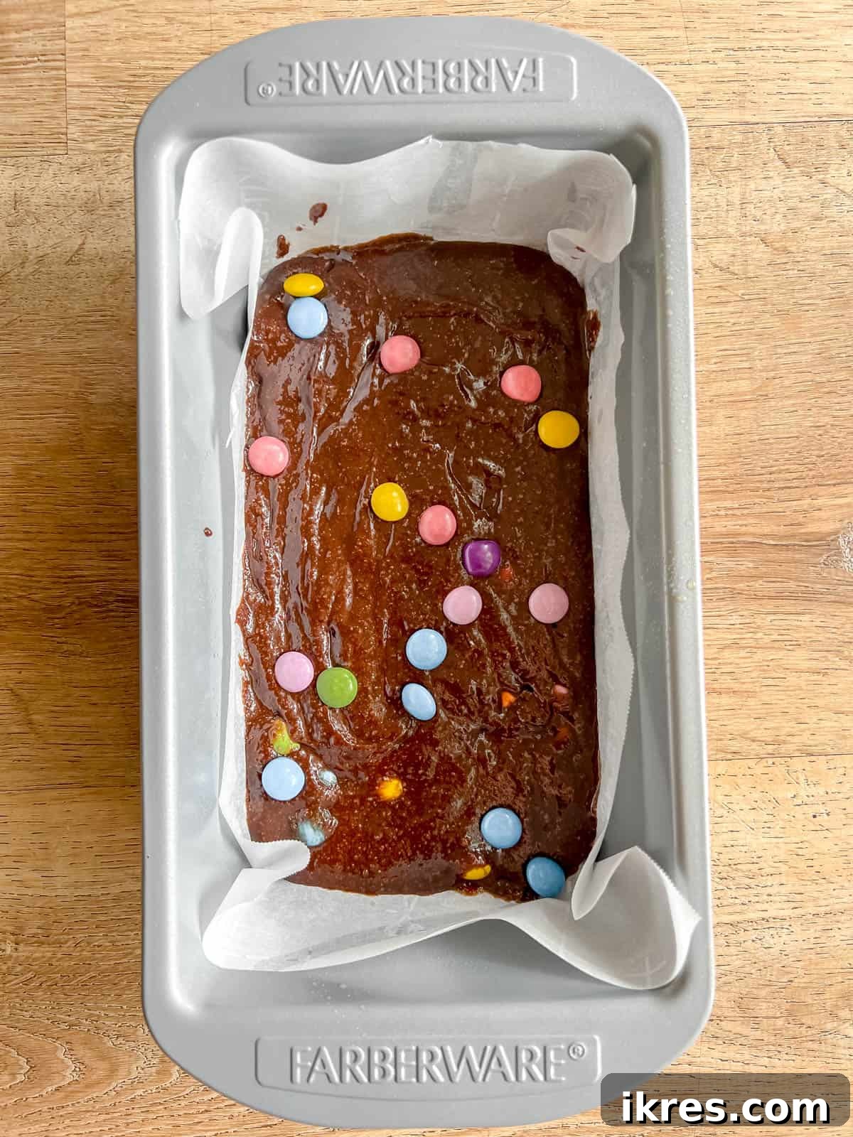 Small Batch Fudgy Almond Flour Brownies (Grain-Free) 6 Almond flour brownie batter evenly spread in a greased and lined loaf pan, ready for baking.